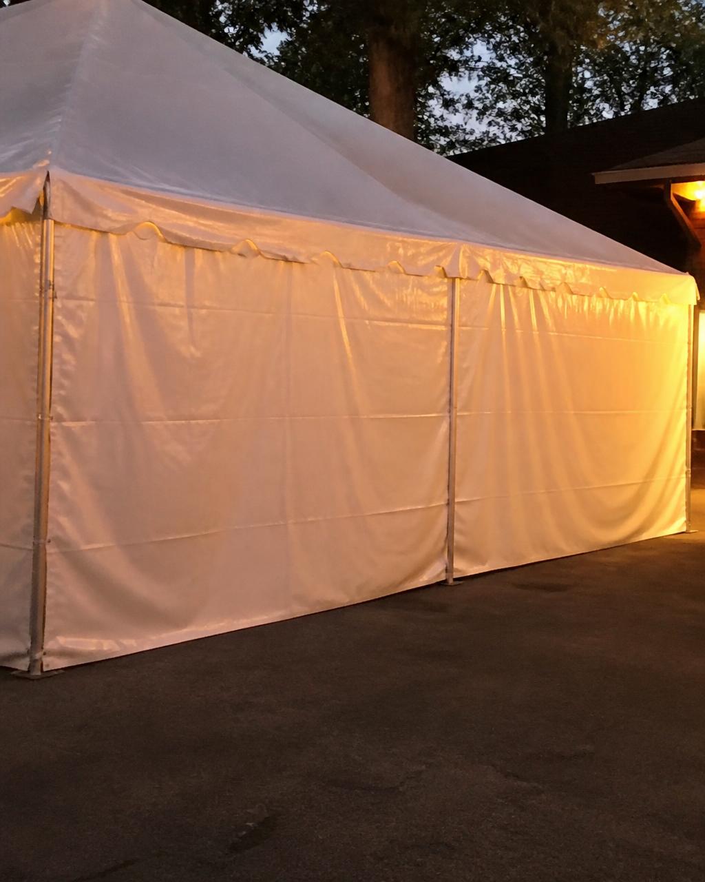 Standard solid white vinyl sidewalls attached to a party tent